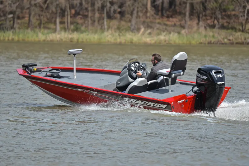 Slide: The Image of 2017 Tracker Pro Team 175 TXW boat cruising on a lake. - 6