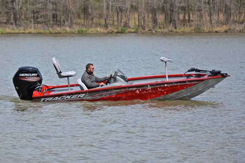 Slide: The Image of 2017 Tracker Pro Team 175 TXW boat on a lake with a Mercury outboard motor. - 7