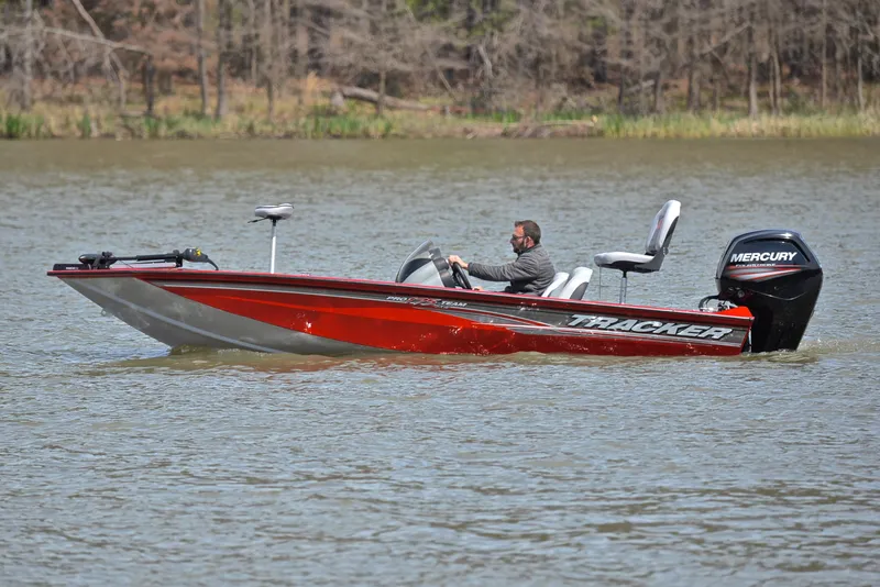 Slide: The Image of 2017 Tracker Pro Team 175 TXW boat on a lake with Mercury outboard motor. - 9
