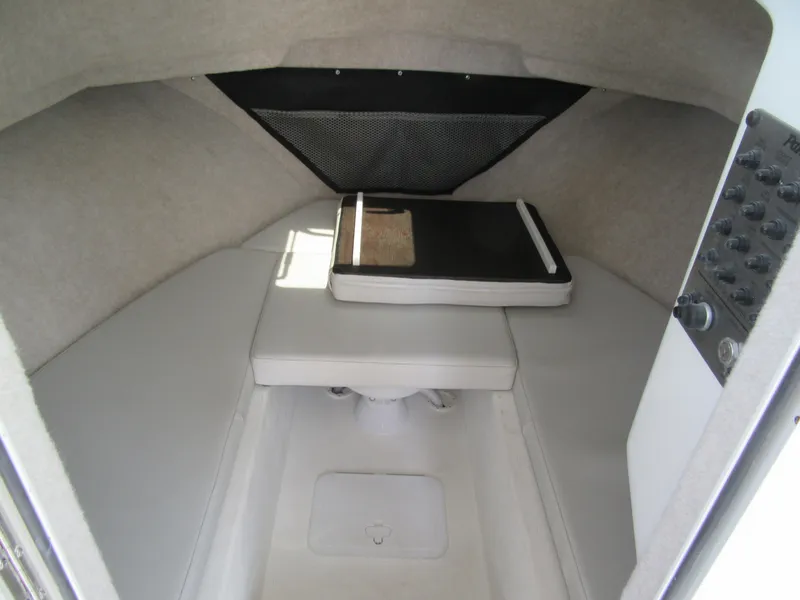 Slide: The Image of 2023 Parker 2520 XLD Sport Cabin interior with cushioned seating and storage. - 12