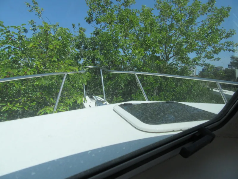 Slide: The Image of View from Parker 2520 XLD Sport Cabin boat, 2023 model, showing bow and lush greenery. - 13