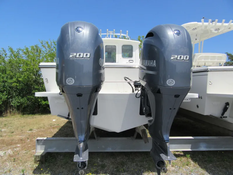 Slide: The Image of 2023 Parker 2520 XLD Sport Cabin with twin Yamaha 200 outboard engines. - 2