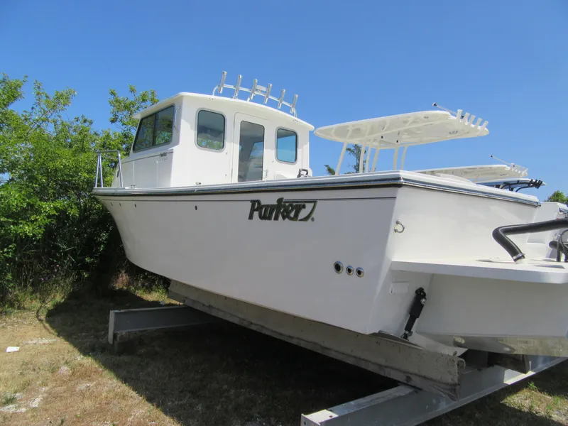 Slide: The Image of 2023 Parker 2520 XLD Sport Cabin boat on a trailer, side view. - 4