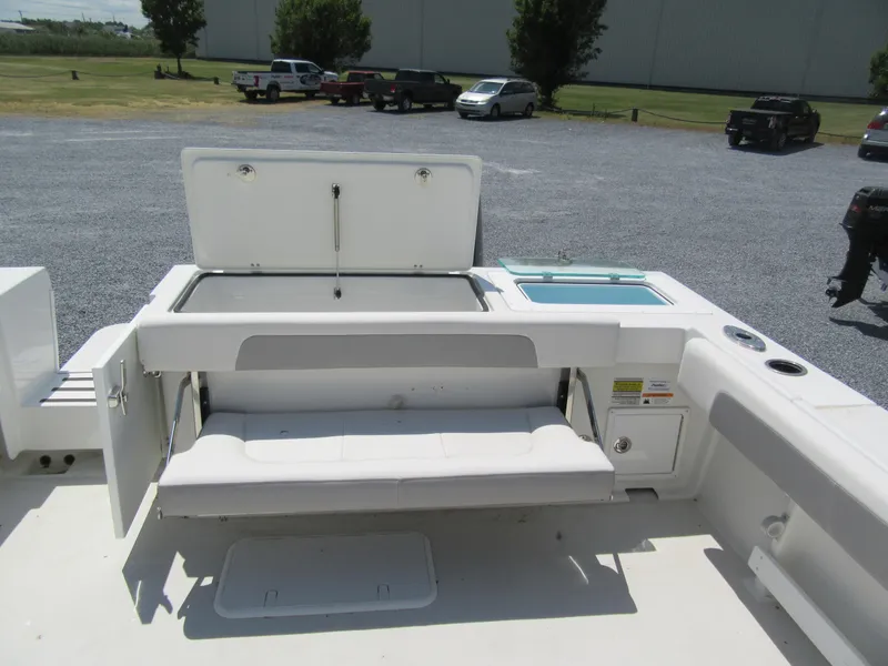 Slide: The Image of 2023 Parker 2520 XLD Sport Cabin boat interior with open storage compartments. - 5