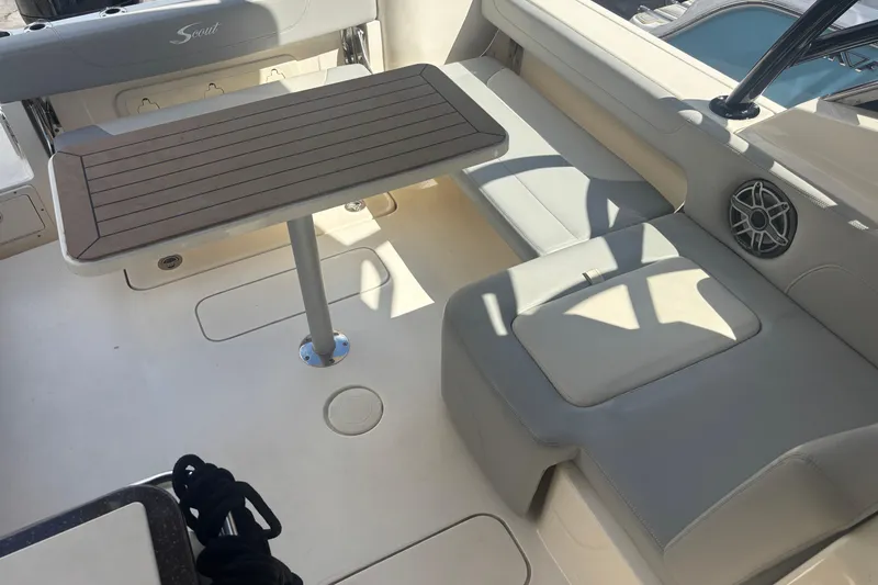 Slide: The Image of 2022 Scout 255 Dorado boat interior with seating and table setup. - 10