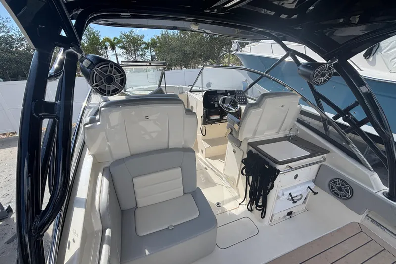 Slide: The Image of 2022 Scout 255 Dorado boat interior with seating and control panel. - 11