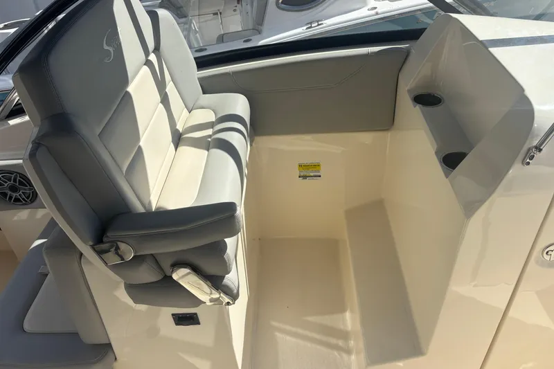 Slide: The Image of 2022 Scout 255 Dorado boat interior with cushioned seating and cup holders. - 15