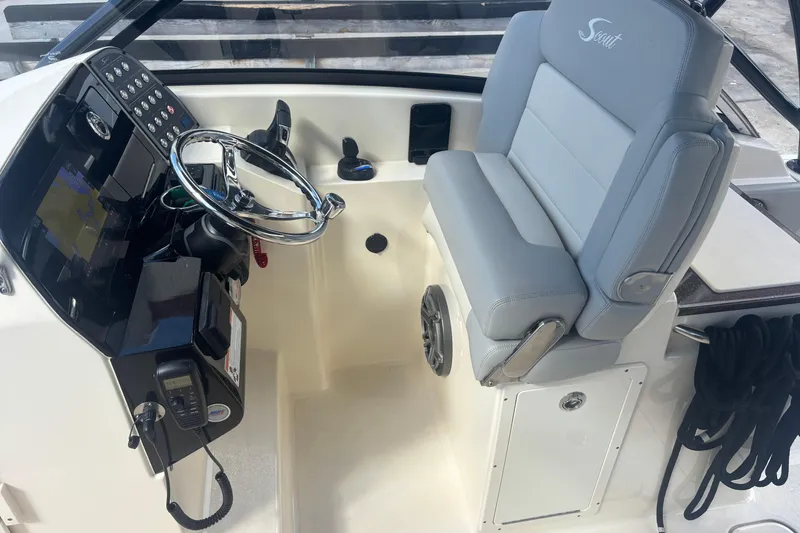 Slide: The Image of 2022 Scout 255 Dorado boat helm with steering wheel and control panel. - 16
