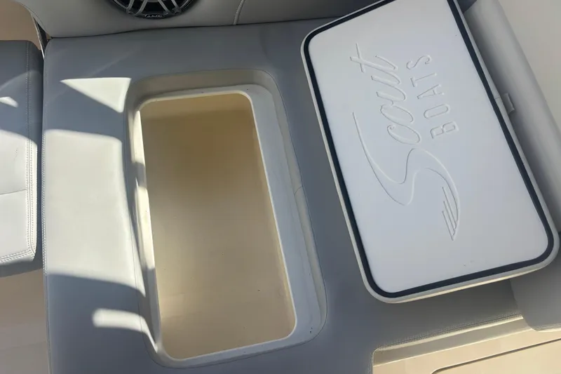 Slide: The Image of 2022 Scout 255 Dorado boat storage compartment with branded lid. - 26