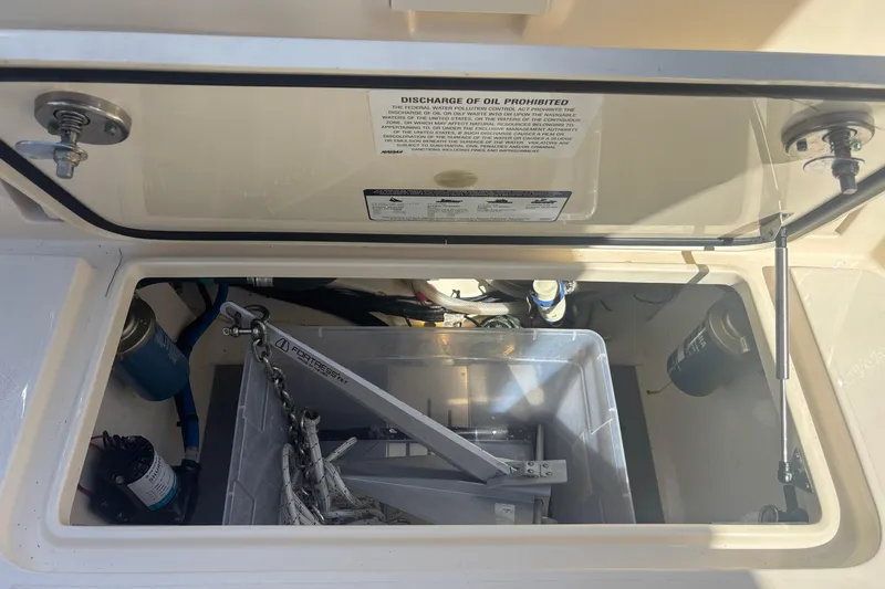 Slide: The Image of Open storage compartment on 2022 Scout 255 Dorado boat with anchor and equipment. - 29