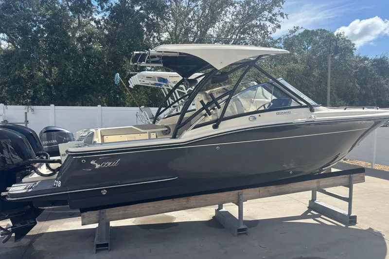 Slide: The Image of 2022 Scout 255 Dorado boat on display, featuring sleek design and dual engines. - 3