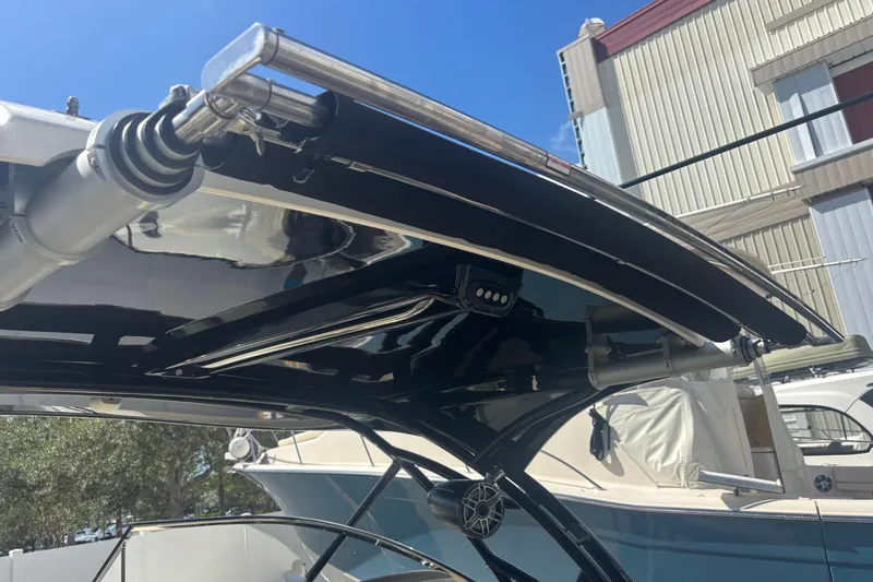 Slide: The Image of 2022 Scout 255 Dorado boat canopy with stainless steel fittings under clear blue sky. - 33