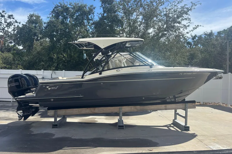 Slide: The Image of 2022 Scout 255 Dorado boat on display, featuring sleek design and dual Yamaha engines. - 6