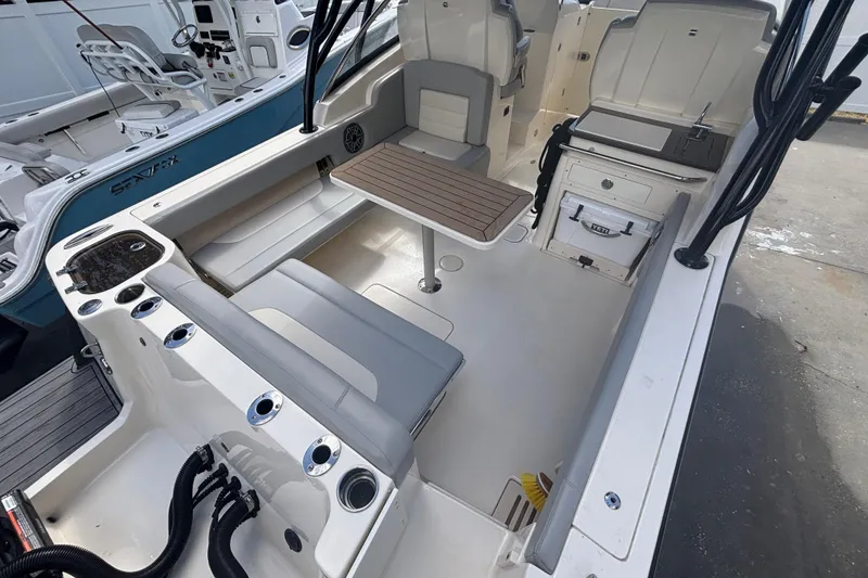 Slide: The Image of 2022 Scout 255 Dorado boat interior with seating, table, and storage features. - 8