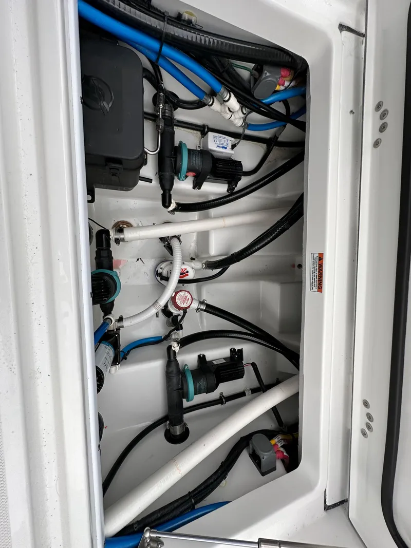 Slide: The Image of 2023 Blackfin 272CC boat engine compartment with wiring and plumbing. - 12