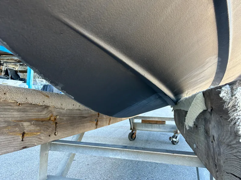 Slide: The Image of Close-up of the hull of a 2014 Chaparral Sunesta 244 boat on a trailer. - 13