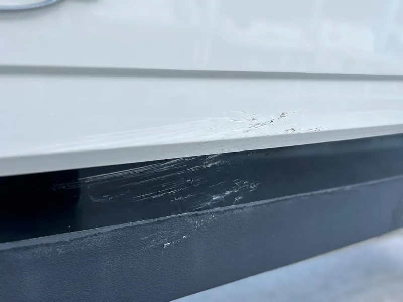 Slide: The Image of Close-up of scratches on a 2014 Chaparral Sunesta 244 boat hull. - 15