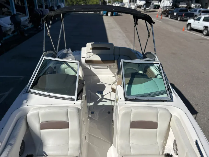 Slide: The Image of 2014 Chaparral Sunesta 244 boat interior with open bow seating and bimini top. - 21