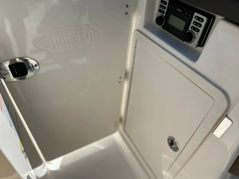 Slide: The Image of Interior of 2014 Chaparral Sunesta 244 boat with storage compartment and control panel. - 28