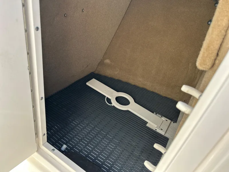 Slide: The Image of Storage compartment of 2014 Chaparral Sunesta 244 boat with carpeted interior. - 29