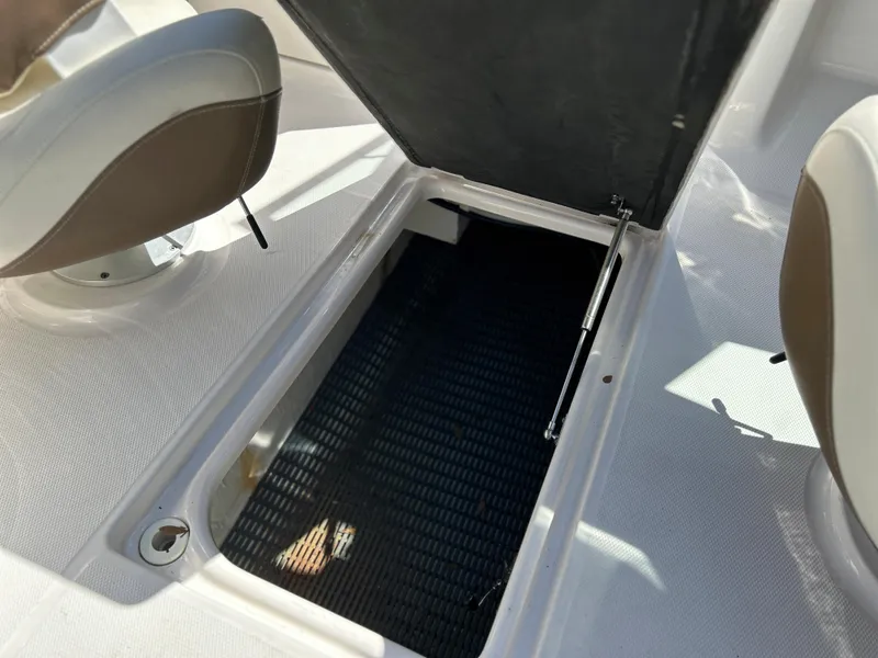 Slide: The Image of 2014 Chaparral Sunesta 244 boat storage compartment with open hatch. - 41