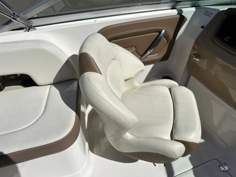 Slide: The Image of 2014 Chaparral Sunesta 244 boat interior with white and brown seating. - 42