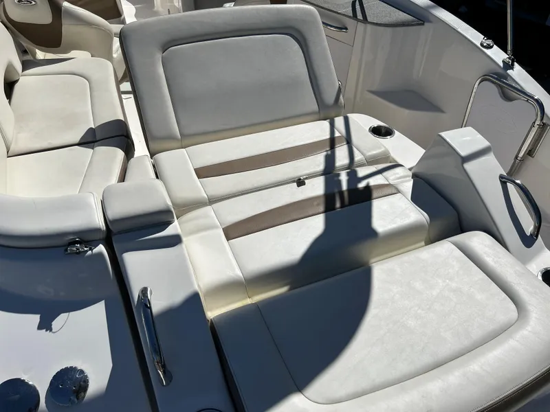 Slide: The Image of 2014 Chaparral Sunesta 244 boat interior with white and beige seating. - 45