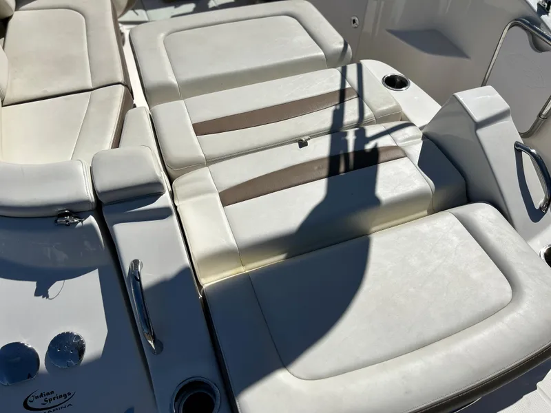 Slide: The Image of 2014 Chaparral Sunesta 244 boat interior with white and beige seating. - 47