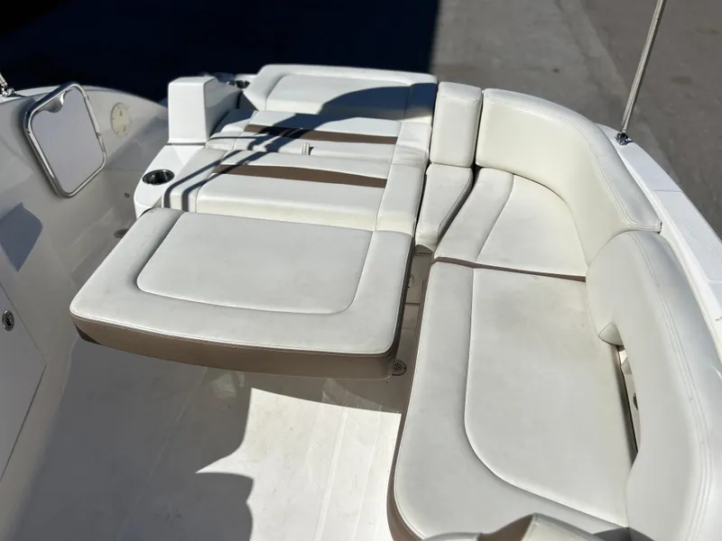 Slide: The Image of 2014 Chaparral Sunesta 244 boat with white cushioned seating area. - 48