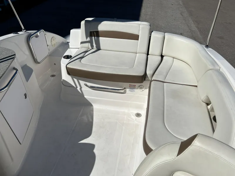 Slide: The Image of 2014 Chaparral Sunesta 244 boat interior with white and beige seating. - 49