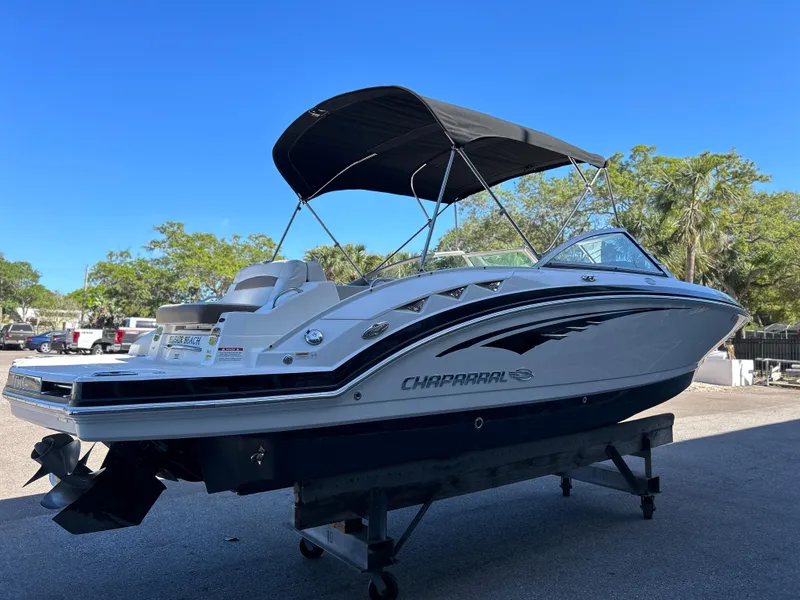 Slide: The Image of 2014 Chaparral Sunesta 244 boat with black bimini top on a trailer. - 7
