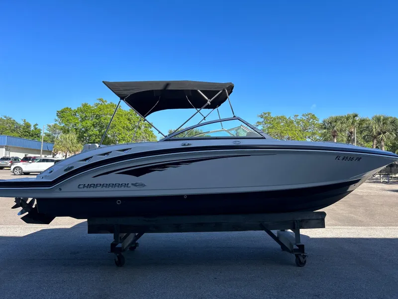 Slide: The Image of 2014 Chaparral Sunesta 244 boat with black canopy on trailer. - 9
