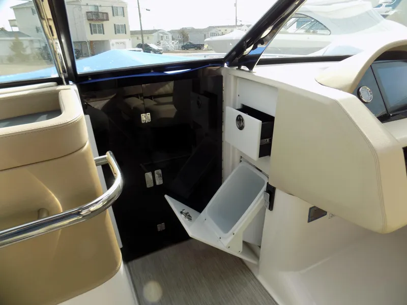 Slide: The Image of 2019 Regal 2800 Bowrider interior with open storage compartments and modern dashboard. - 10