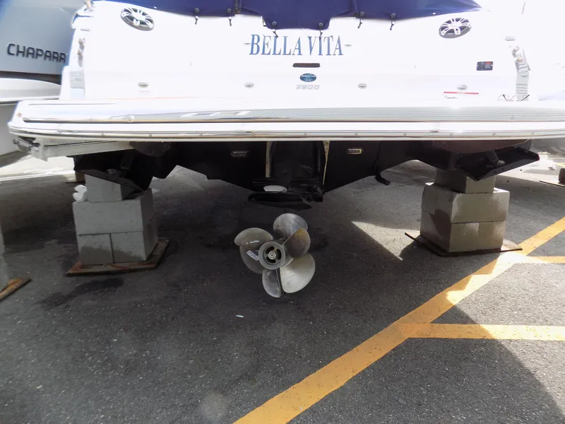 Slide: The Image of 2019 Regal 2800 Bowrider boat on blocks, showing propeller and rear view. - 11