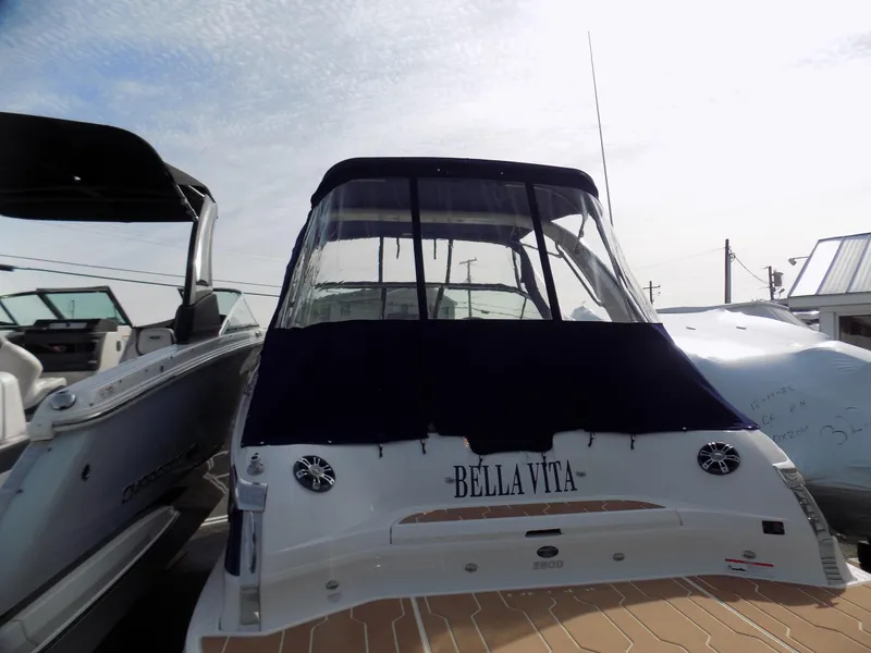 Slide: The Image of 2019 Regal 2800 Bowrider boat with "Bella Vita" name, docked under a cloudy sky. - 3