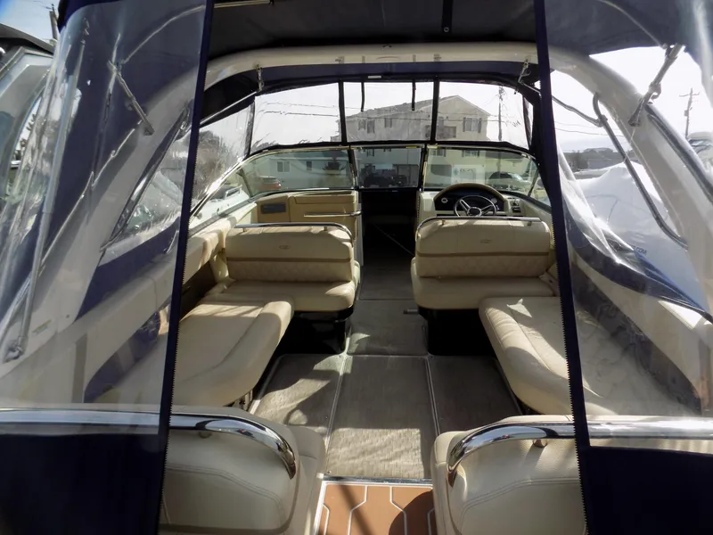 Slide: The Image of 2019 Regal 2800 Bowrider interior with beige seating and clear canopy. - 4