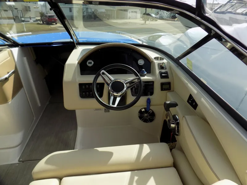 Slide: The Image of 2019 Regal 2800 Bowrider helm with steering wheel and control panel. - 5