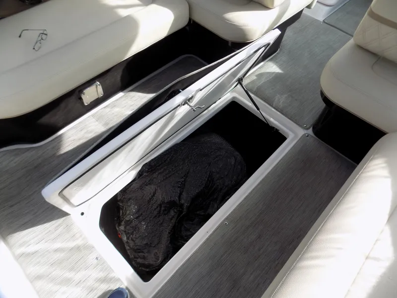 Slide: The Image of 2019 Regal 2800 Bowrider boat storage compartment with open lid, revealing interior space. - 8