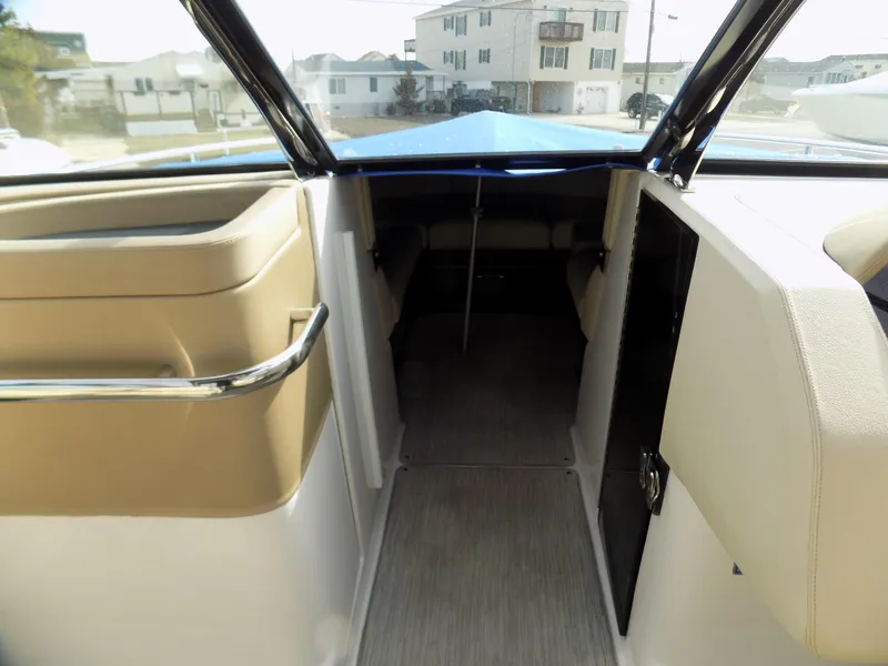 Slide: The Image of 2019 Regal 2800 Bowrider interior view with beige seating and open cabin area. - 9