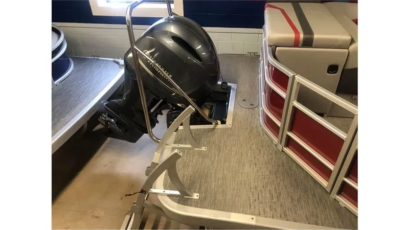 Slide: The Image of 2023 Bennington 24SXL pontoon boat with outboard motor and red seating. - 4