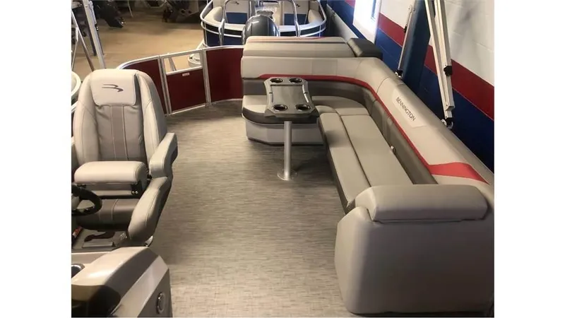 Slide: The Image of 2023 Bennington 24SXL pontoon boat interior with plush seating and captain's chair. - 6