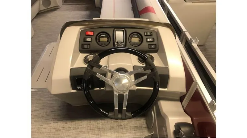 Slide: The Image of 2023 Bennington 24SXL boat dashboard with steering wheel and control panel. - 8
