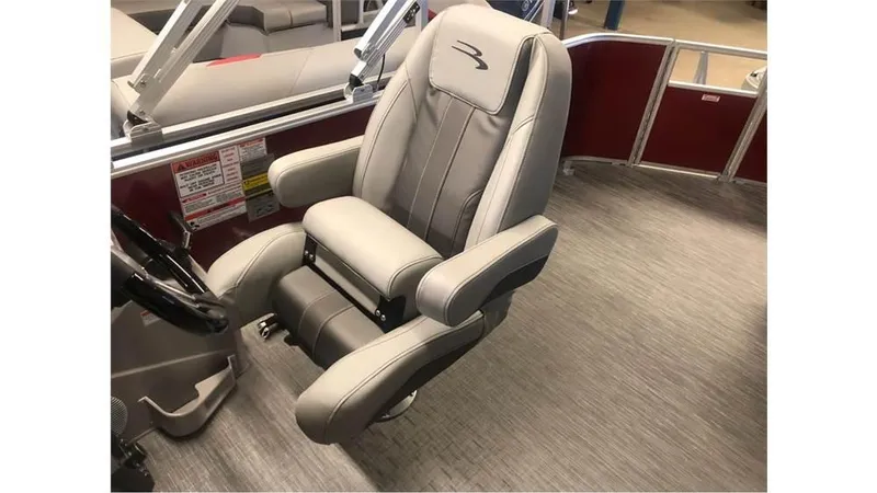 Slide: The Image of 2023 Bennington 24SXL boat captain's chair with gray upholstery and armrests. - 9
