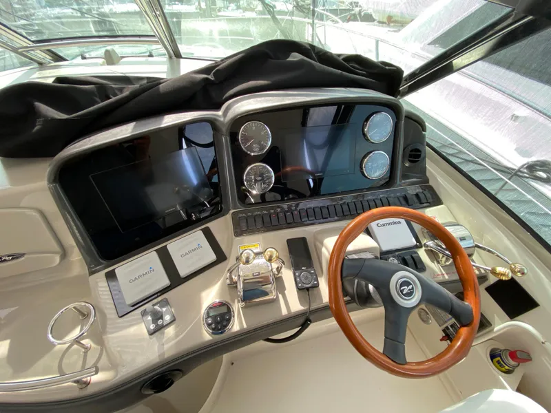 Slide: The Image of 2006 Sea Ray Sundancer 44 helm with modern navigation instruments and wooden steering wheel. - 14