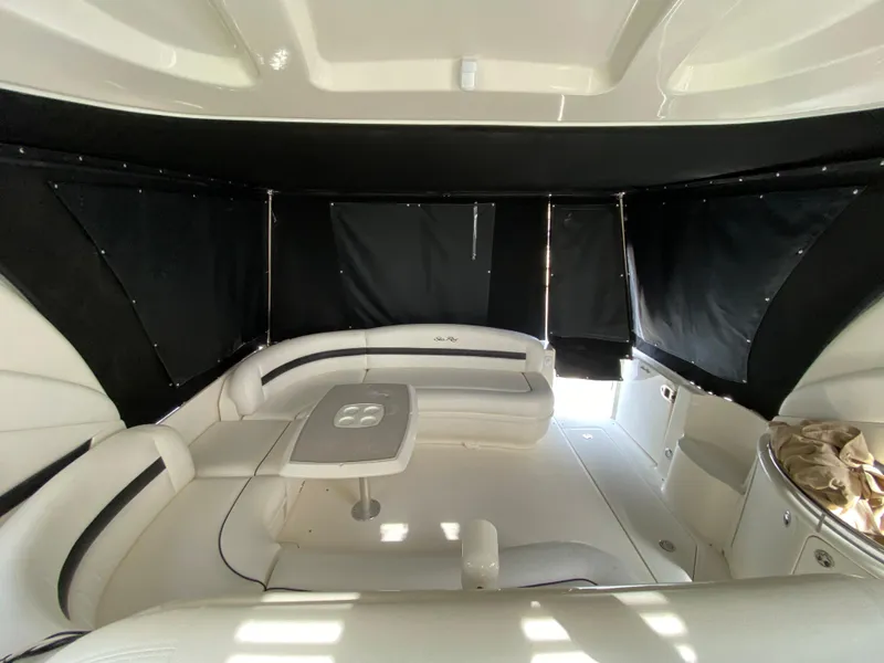 Slide: The Image of 2006 Sea Ray Sundancer 44 interior with white seating and table. - 18