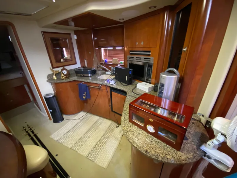 Slide: The Image of Interior of 2006 Sea Ray Sundancer 44 yacht with wooden cabinetry and granite countertops. - 21