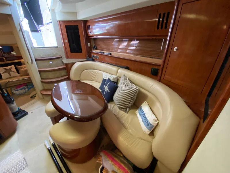 Slide: The Image of Luxurious interior of 2006 Sea Ray Sundancer 44 with leather seating and wooden table. - 26