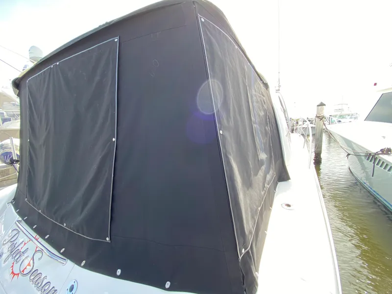 Slide: The Image of 2006 Sea Ray Sundancer 44 with black canvas cover docked at marina. - 8