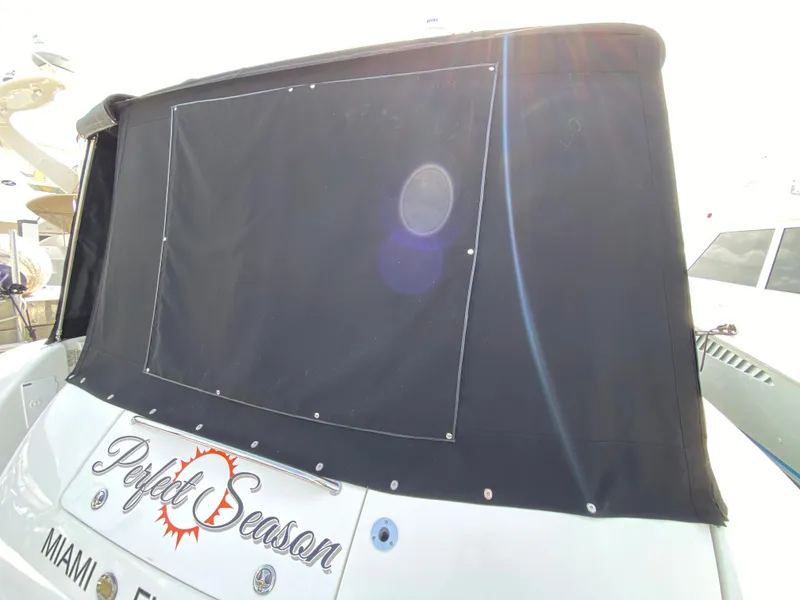Slide: The Image of 2006 Sea Ray Sundancer 44 yacht with black canvas cover, named Perfect Season, docked in Miami, Florida. - 9