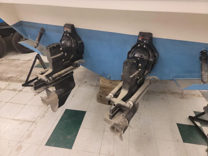 Slide: The Image of 1992 Sea Ray 330 Sundancer boat stern with dual MerCruiser outdrives in a workshop. - 16